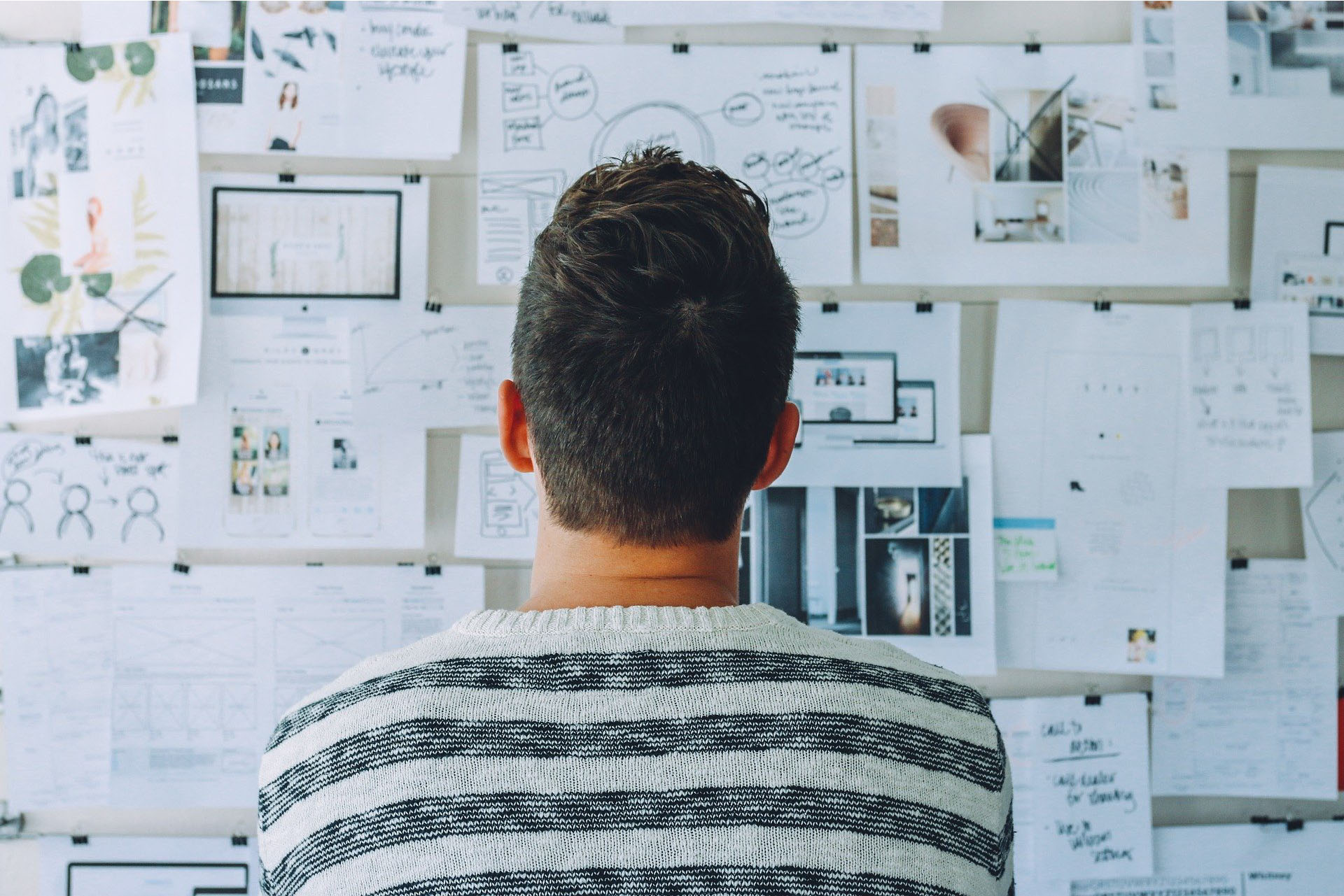 Man looking at website ideas on an idea board